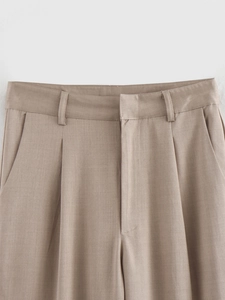 Close-up of khaki casual trousers showing twill fabric texture and waist detail