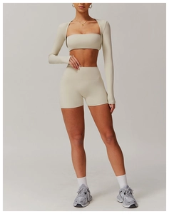 Three-piece oatmeal yoga set including cropped jacket, sports bra, and high-waist leggings