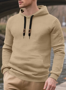 Detailed view of khaki waffle texture fabric and black drawstring on men hoodie