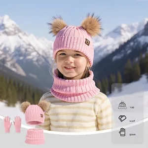 Pink winter knit set for kids featuring dual pom-poms hat, scarf, and touch gloves