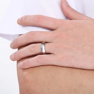 Macro shot of minimalist silver stainless steel ring with streamlined faceted details