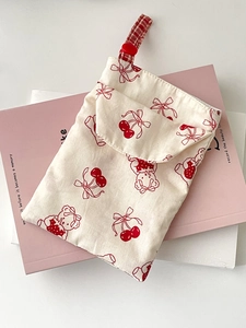 Cute off-white canvas pouch with red cherry and bear patterns on a soft background