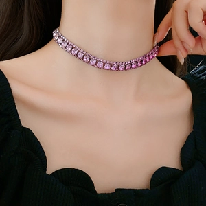 Detailed close-up of a pink gradient crystal necklace on model's neck and collarbone