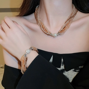 Close-up of layered beaded necklace and bracelet with sparkling magnetic clasps