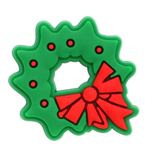 Close-up of a green Christmas wreath shoe charm with a red bow for clog decoration