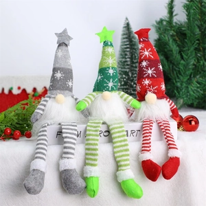 Three Christmas long-legged faceless gnomes in gray green and red knitted star hats