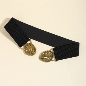 Detail of vintage golden crane relief buckle on a wide black elastic waist belt