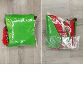 Detail view of a large Christmas stocking in festive red and green felt inside packaging