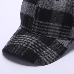 Detail of checkered wool fabric and high-quality stitching on the baseball cap brim