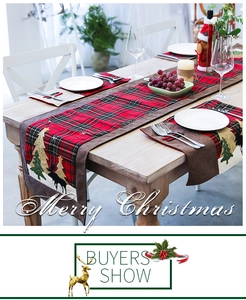 Detail of red and black buffalo plaid Christmas table runner with elk and pine tree embroidery
