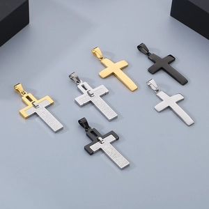 Macro view of stainless steel cross pendants featuring Lord's Prayer engraving details