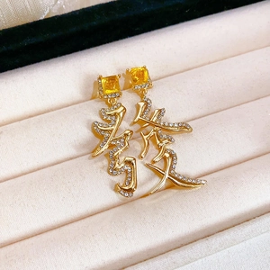 Gros plan détaillé de boucles d'oreilles chinoises dorées avec gemmes jaunes et strass pavés