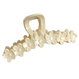 Creamy floral hair claw clip featuring small daisies on minimalist acrylic hair accessory