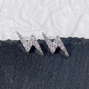 Close-up of mini silver lightning bolt earrings with pavé cubic zirconia inlay