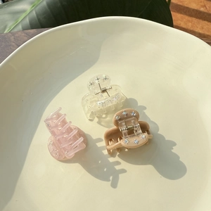 French style mini acetate hair clips set with sparkling rhinestones in a ceramic dish