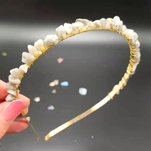 Close-up of handmade gold metal headband with raw white translucent crystal stones