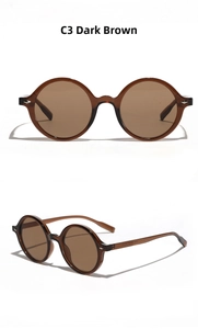 Detail view of dark brown round sunglasses with metal studs and an integrated nose pad