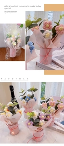 Detail of handmade crochet flower bouquet in pink packaging with warm LED lights