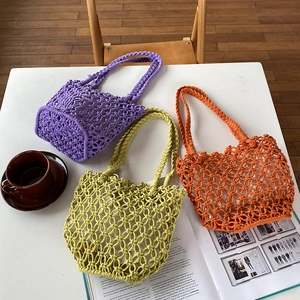 Detailed top view of handmade woven mesh bags in purple, lime green, and orange colors