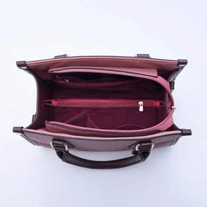 Top view of multi-compartment interior and two-tone crocodile pattern handbag in burgundy