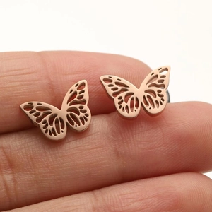 Detailed macro view of rose gold hollow butterfly earrings with intricate wing patterns