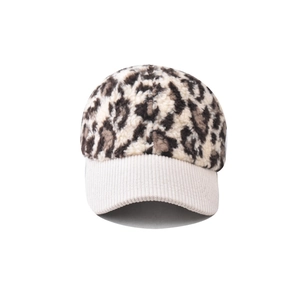 Detail of leopard print faux fur texture and beige corduroy brim on baseball cap