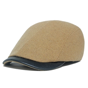 Vintage camel wool blend flat cap with black leather brim and classic twill texture