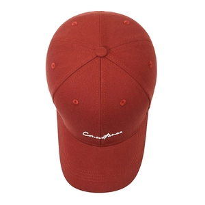 Classic deep red cotton baseball cap with white script embroidery in a top-down view