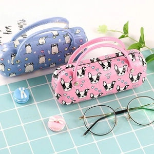 Close-up of portable leather eyewear cases with cartoon animal prints and sturdy handles