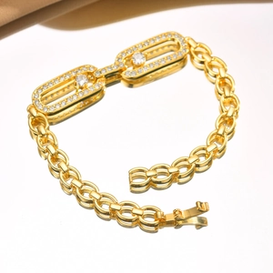 Macro shot of gold bracelet with sparkling zircon stones in a sliding rectangular clasp design