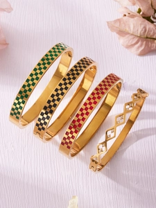 Detail of checkered enamel bangles and diamond studded geometric gold bracelet