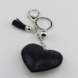 Sparkling black heart keychain with rhinestone inlay and stylish tassel on white background