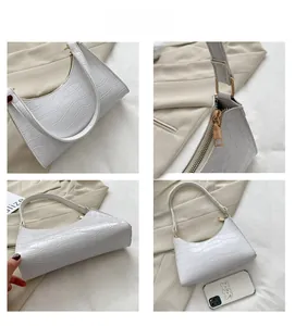 Detailed views of white crocodile pattern baguette bag with golden hardware and zipper