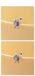 Close-up of planet-shaped zircon earrings with blue and purple stones and screw back