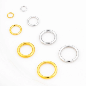 Close-up of gold and silver stainless steel jump rings in various sizes for jewelry making
