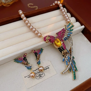 Elegant parrot jewelry set with pearls and colorful crystals in a luxury velvet box
