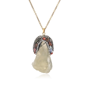 Detail of yellow crystal pendant with multicolor rhinestones on a gold chain