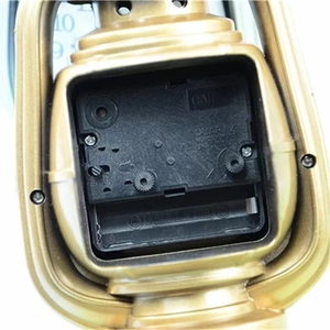 Close-up of motorcycle alarm clock back showing golden shell and quartz movement