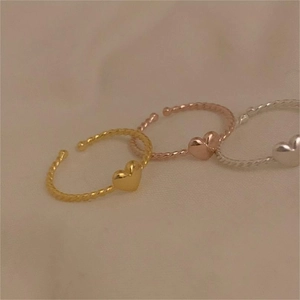 Three-tone heart-shaped adjustable twist rings in gold, silver, and rose gold finish