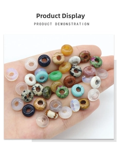 Close-up of mixed natural gemstone donut beads for DIY jewelry held in a hand