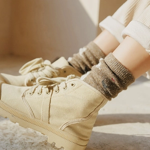 Retro flecked beige wool socks paired with stylish cream canvas high-top work boots