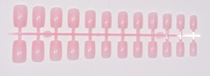 Detailed view of 24 pieces light pink square fake nails on factory plastic holder strip
