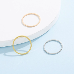 Detailed view of 3-piece stainless steel ring set in gold, silver, and rose gold finishes