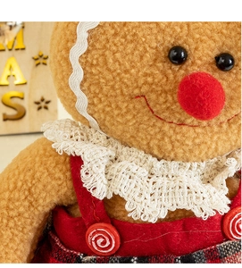 Detailed macro view of gingerbread man plush doll with red plaid and soft sherpa texture