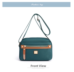 Detailed front view of dark green water-resistant nylon crossbody bag with leather trim