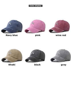 Multiple colors display of cotton baseball caps featuring embroidered balloon dog design