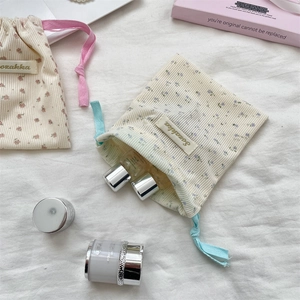 Close-up of floral corduroy drawstring pouches for travel cosmetics and makeup storage