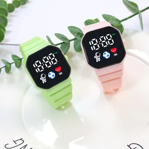 Detailed view of pink and green LED watches with astronaut icons and silicone straps