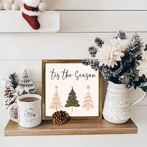 Wooden Christmas tree wall art frame and holiday ornaments on a rustic shelf