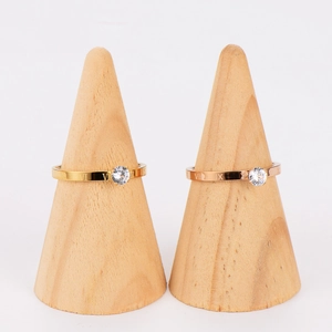 Shiny Roman numeral rings with zircon in gold and rose gold on conical stands